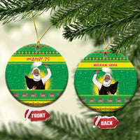 Green round ceramic Christmas ornament with bearded figure design and gold hanging loop