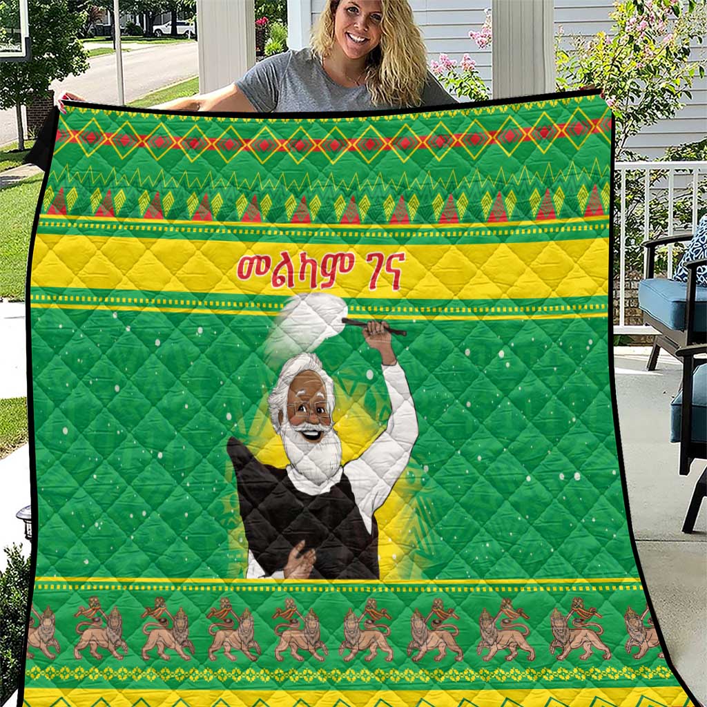 Green quilt with quilted diamond texture, red/yellow trim, central raised-arms figure, horse border