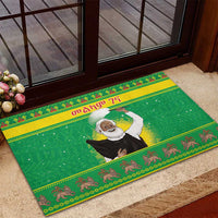 Green rubber Christmas doormat with Santa-style figure and animal motif trim, rectangular