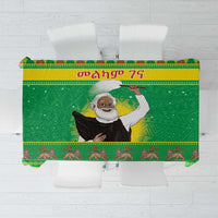 Green Christmas tablecloth with central Santa figure and decorative border pattern