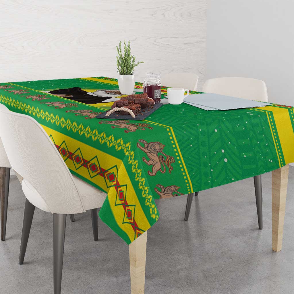 Green Christmas tablecloth with illustrated motifs and bordered pattern on tabletop