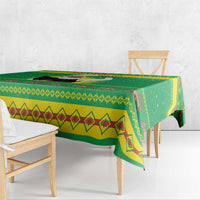 Green Christmas tablecloth corner view with geometric diamond trim and zigzag band