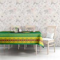 Green Christmas tablecloth on dining table with diamond-pattern stripe border