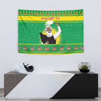 Green Christmas wall tapestry featuring Ethiopian priest figure with festive band