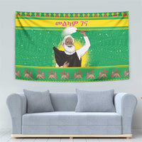 Green Christmas wall tapestry with Ethiopian priest figure and dancing animal border