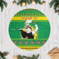Green round Christmas tree skirt with central figure and colorful patterned border