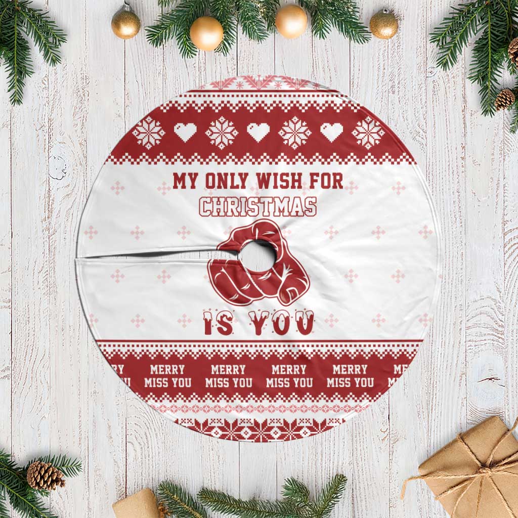 Red-and-white Christmas tree skirt with festive text, reindeer heart graphic, and fringe edge