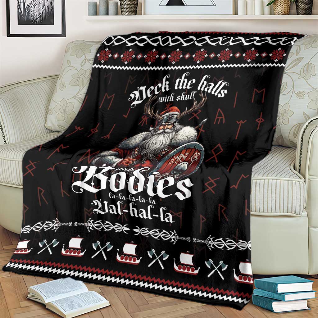 Black Viking-themed throw blanket with red/white design on a living room couch