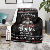Black Viking skull Christmas blanket on a grey chair, bold red and white pattern