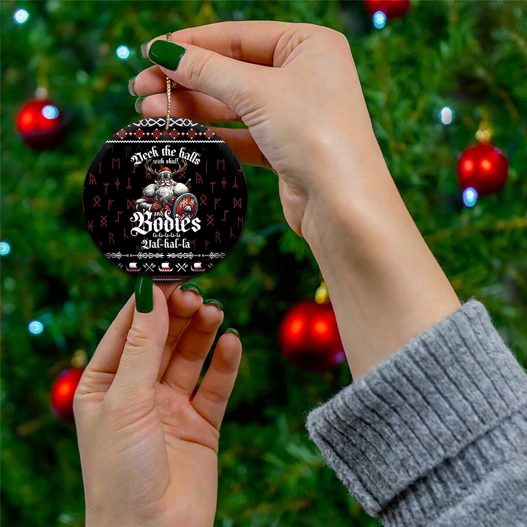Black round ceramic Christmas ornament held by hand, Viking warrior graphic and text
