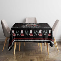 Black Viking holiday tablecloth on a small table, featuring red and white accents