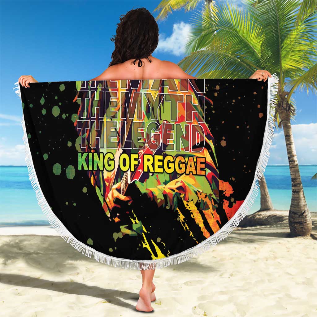 Black round beach blanket with white fringed edge, large reggae graphic with text