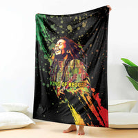 Black oversized graphic blanket draped with reggae musician portrait and bold colors