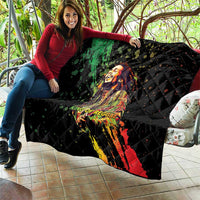 Black quilted couch throw blanket with colorful reggae king portrait graphic and diamond quilting.