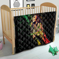 Black quilted crib blanket with colorful reggae king portrait graphic and diamond stitch design.