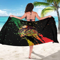 Black sarong showing colorful reggae performer graphic across center, flowing drape