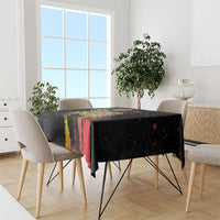 Black tablecloth with bright multicolor paint-splash stripes on dining table