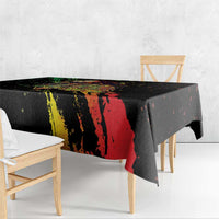 Black tablecloth over table edge with red and yellow streaky graffiti pattern