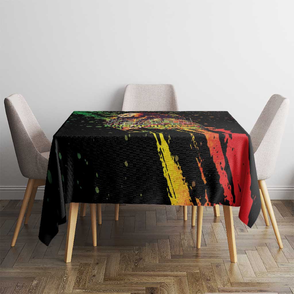 Black tablecloth on dining table with multicolor paint stripe design and speckles