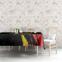 Black tablecloth with multicolor graffiti print featuring red, yellow, and green