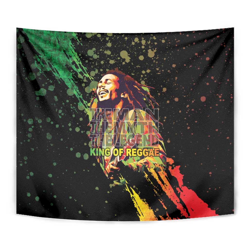 Black tapestry wall hanging close-up: reggae portrait with green, red, yellow paint streaks
