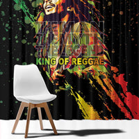 Black curtain panel with centered reggae musician graphic and multicolor text background