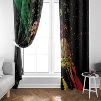 Black window curtains framing a doorway, with reggae portrait and red-yellow splatter