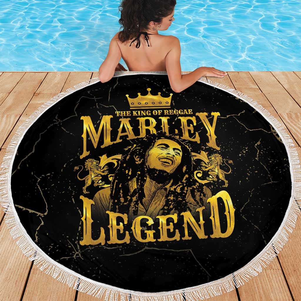 Round black “Marley Legend” beach blanket with gold portrait, crown, and white fringe