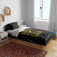 Black bedding set with gold Marley Legend duvet on bed and two black pillowcases