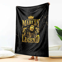 Black fleece blanket with gold Marley Legend crowned portrait, draped on floor