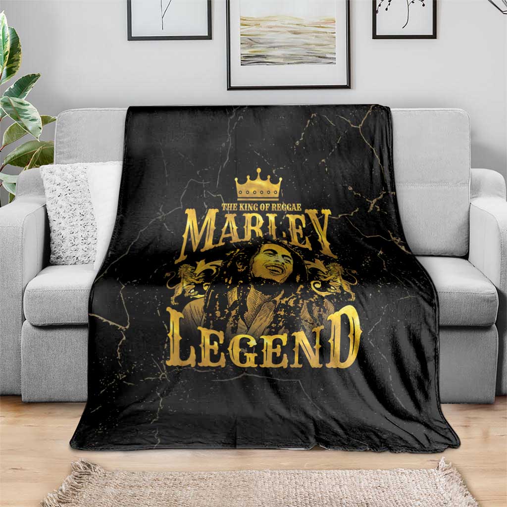 Black fleece blanket with gold King of Reggae Marley Legend portrait, spread on sofa