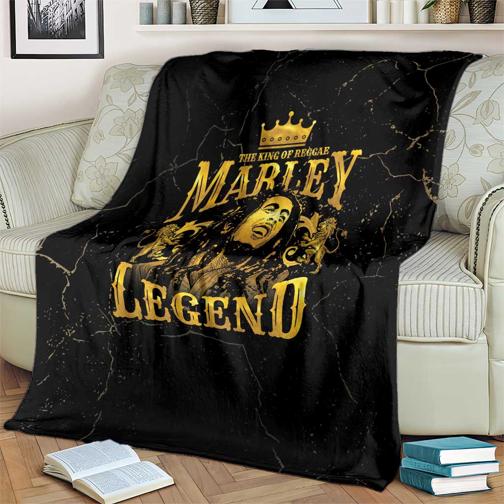 Black fleece blanket with gold Marley Legend crown portrait, draped over couch