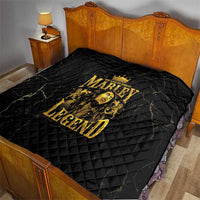 Black bed quilt with gold “MARLEY LEGEND” print on quilted diamond surface