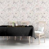 Black tablecloth with gold Marley “Legend” print, covering dining table with side drape