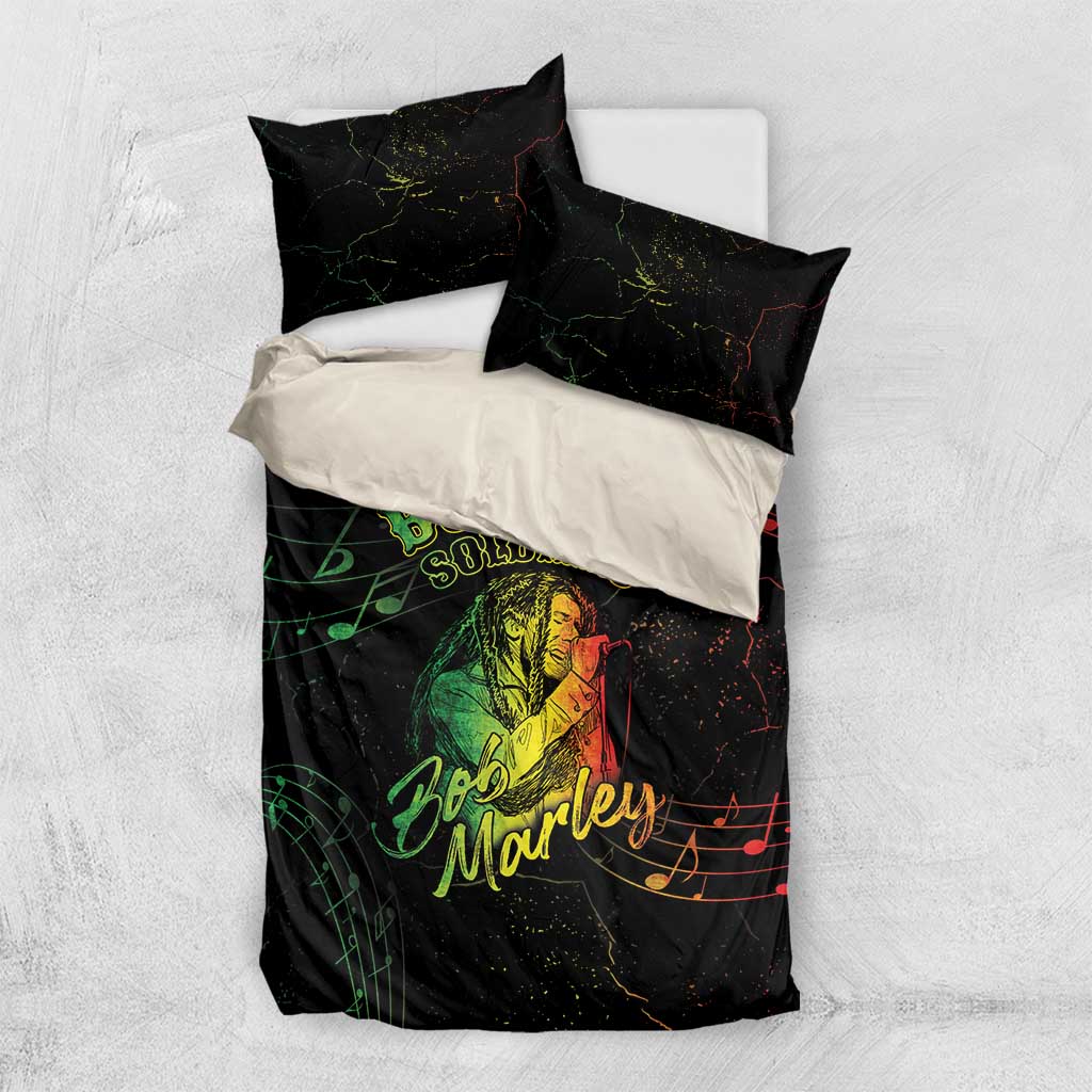 Black duvet and two pillows with red and green musical notes and Bob Marley graphics