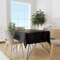 Black printed tablecloth with red and green streak graphics on dining table