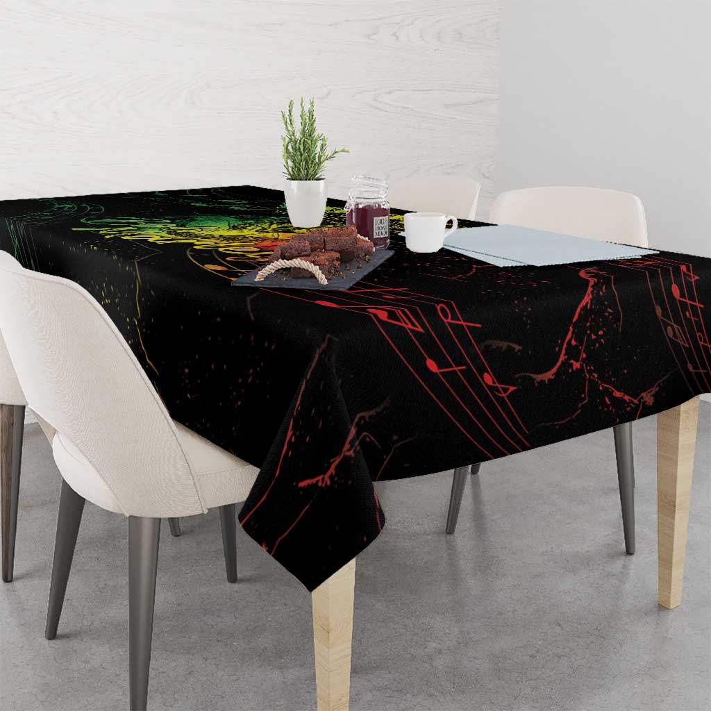 Black printed tablecloth with red music-note lines and yellow portrait graphic