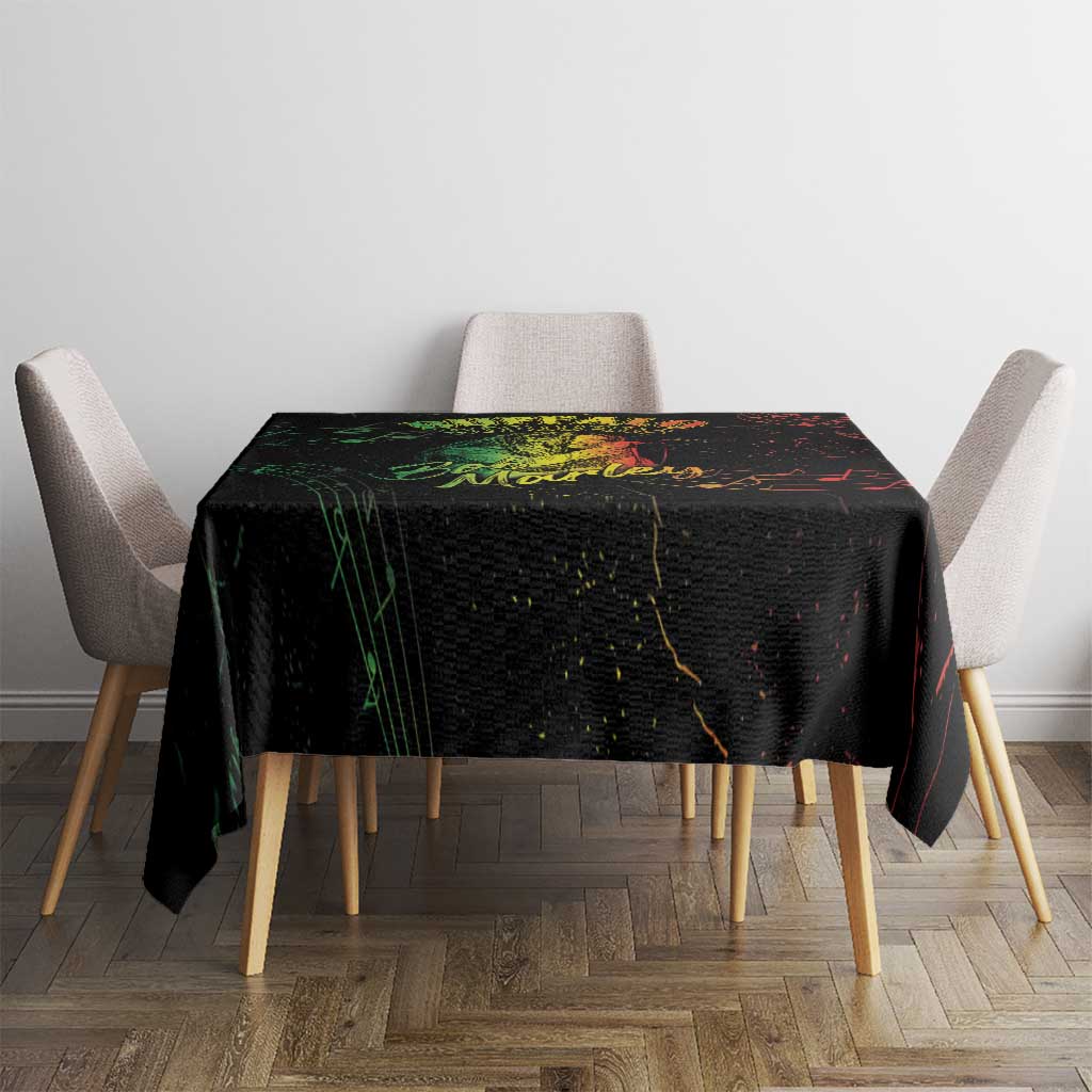 Black printed tablecloth on dining table with red, green, and yellow splatter artwork