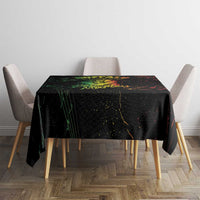 Black printed tablecloth on dining table with red, green, and yellow splatter artwork