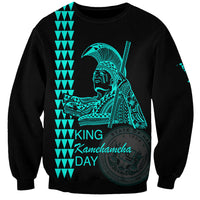 Unisex black sweatshirt with teal King Kamehameha Day graphic and text on front