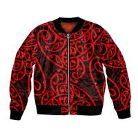 Red bomber jacket with Maori-style swirl pattern, black zip front, ribbed collar and cuffs