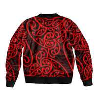 Red bomber jacket with bold black-and-red Maori-style swirls, ribbed collar and cuffs