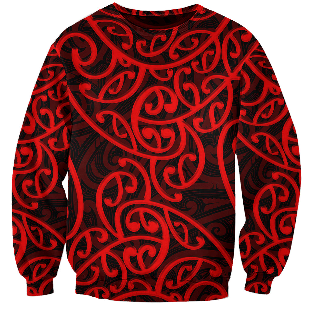 Red crewneck sweatshirt with bold dark Maori-style swirling pattern, long sleeves