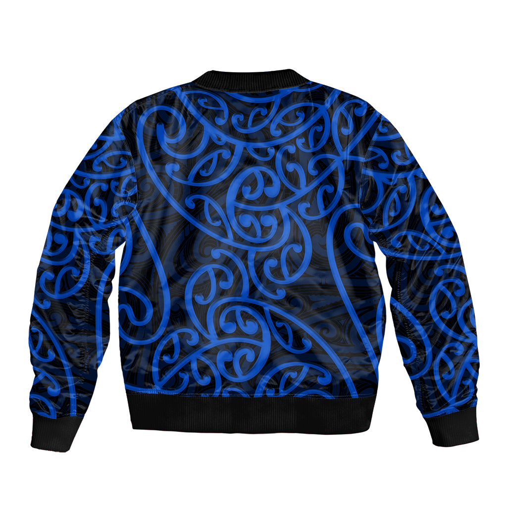 Blue bomber jacket with Maori-style swirl pattern, ribbed collar and cuffs