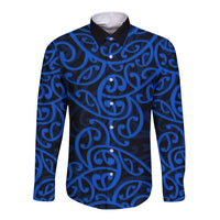 Blue long-sleeve button shirt with black collar and swirling Maori pattern