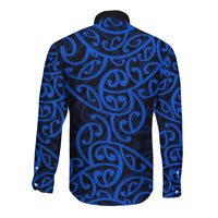 Blue long-sleeve button shirt with swirling Maori pattern on the back