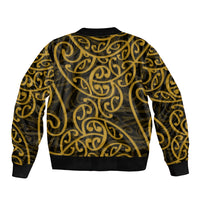 Bomber jacket with gold swirl Maori pattern, black ribbed cuffs and hem, front view