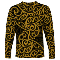 Gold long-sleeve crew-neck shirt with dark Maori swirl pattern across the front