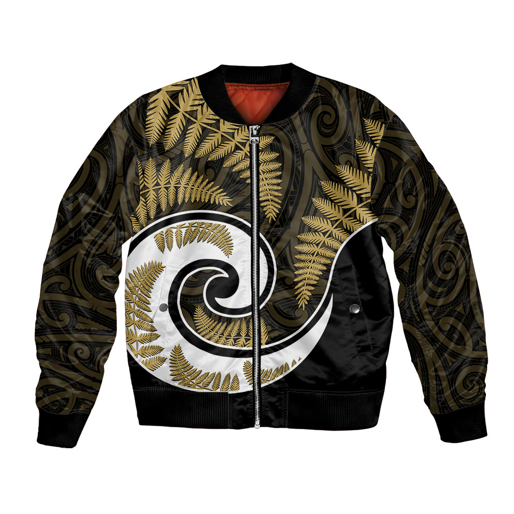 Gold bomber jacket with black ribbed trim, front zip, Maori leaf and fern swirl graphic