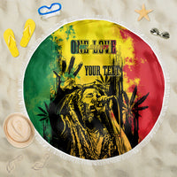 Round fringed beach blanket with reggae grunge graphic and centered "YOUR TEXT" print.